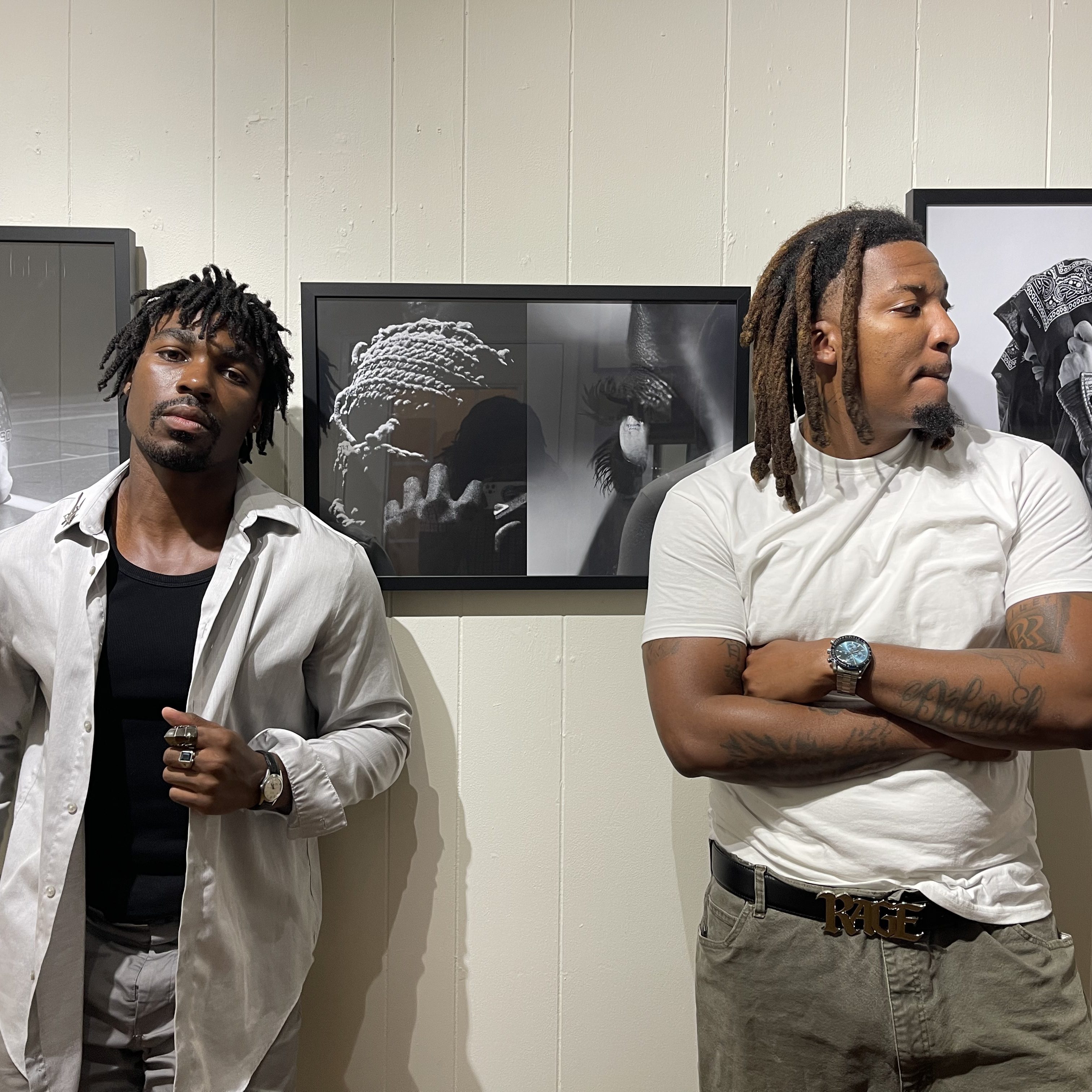 Photographers Ezra and ThirdEye pose in front of their work at the "Nearsighted" gallery